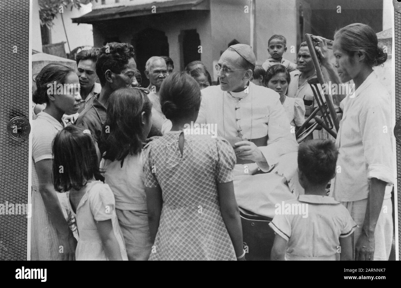 [a man in church habit (bishop?) speaks with wetting Annotation: Is not P.J. Willekens. Could be chief almsman Mgr. Van Straelen. But here he wears glasses. On photos where he wears a uniform, he does not have glasses) Date: 1947/01/01 Location: Indonesia, Dutch East Indies Stock Photo