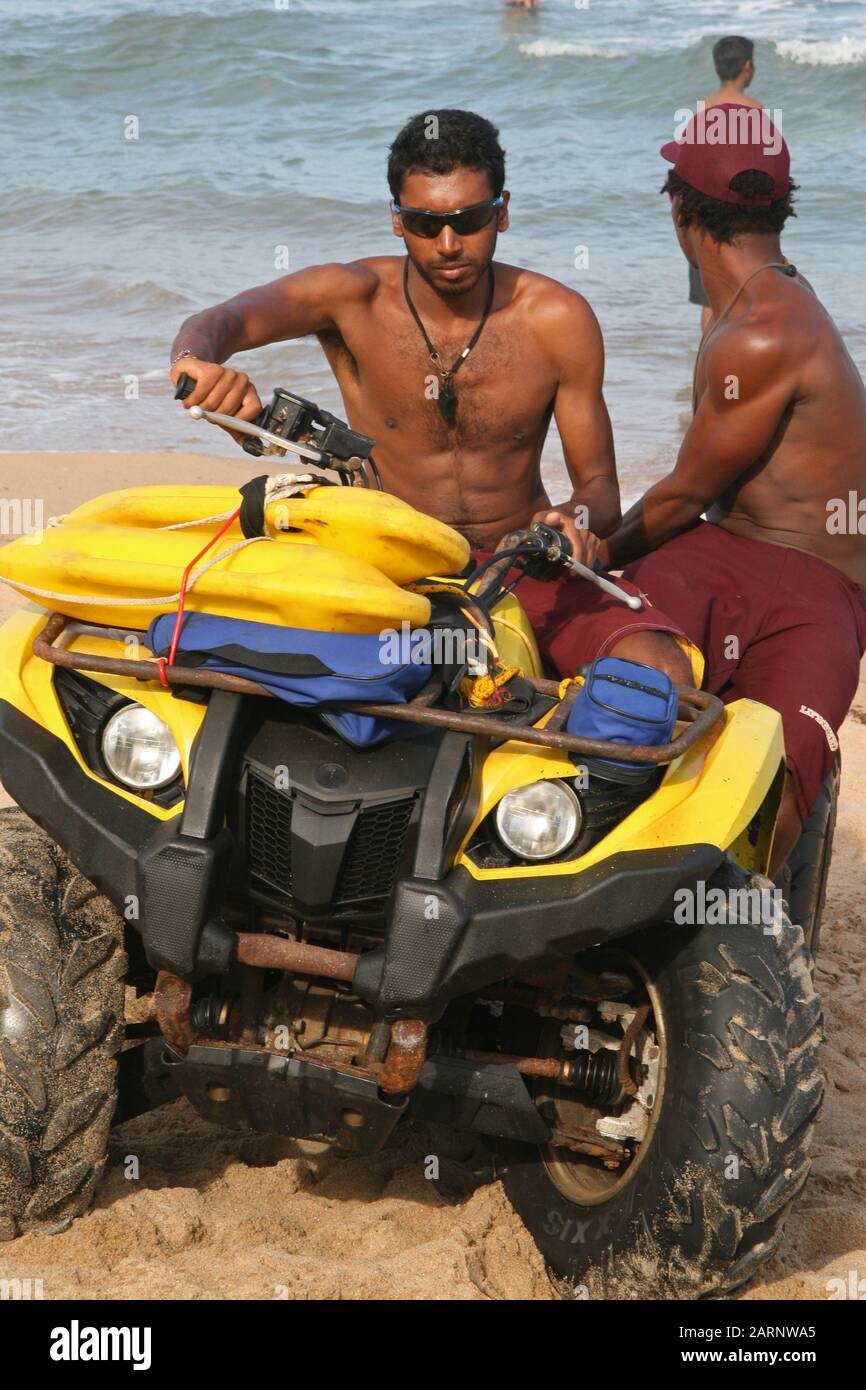 Two lifequards on quad bike buggy on beach, Umdloti, North Coast of