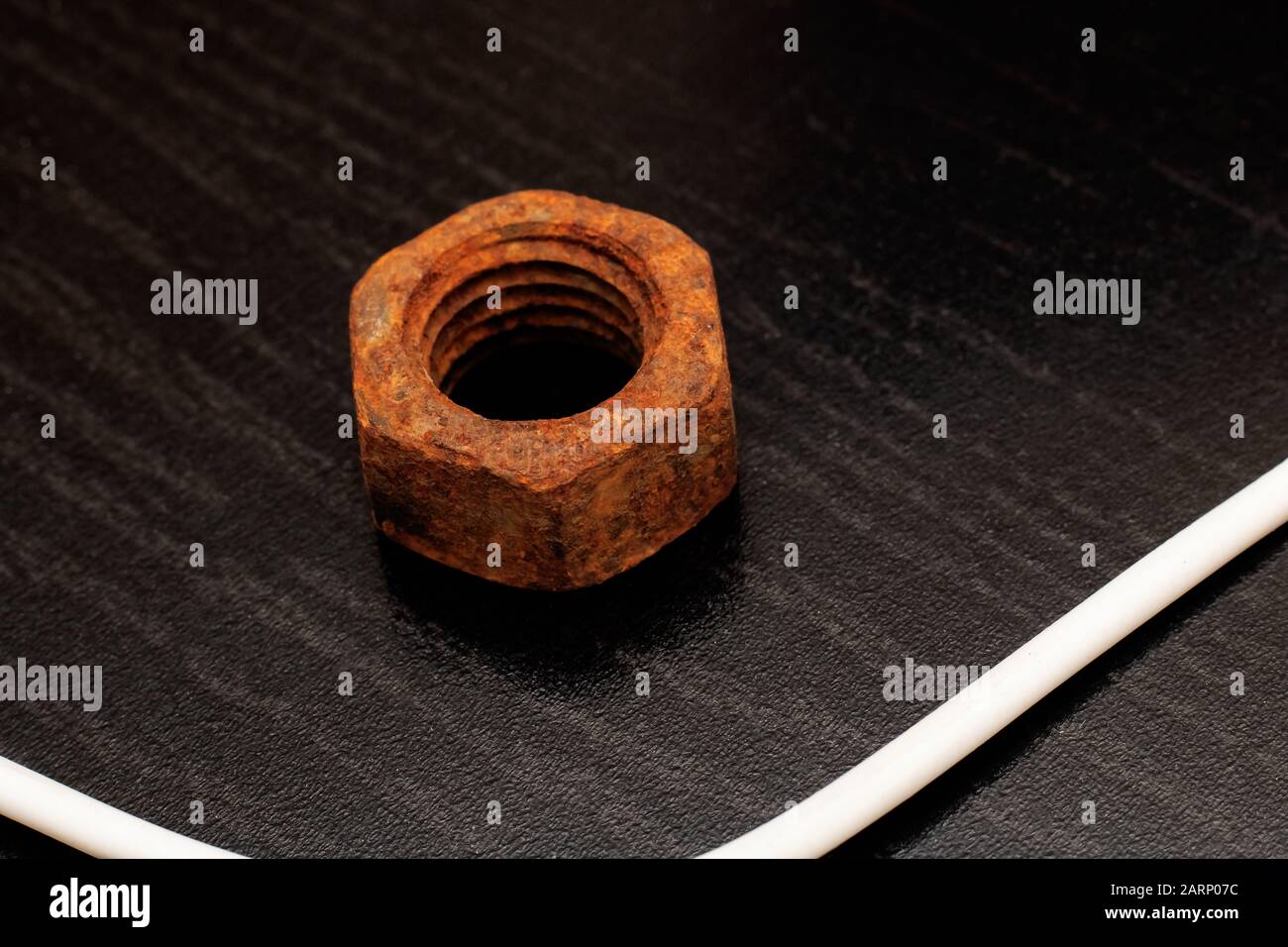 Large old rusty nut close up on black background Stock Photo