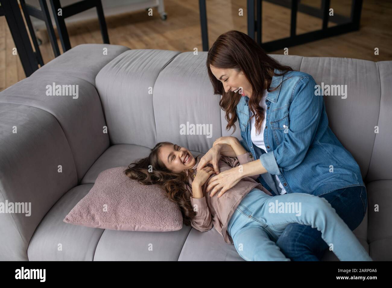 Daughter and mom play fun and joy at home. Stock Photo