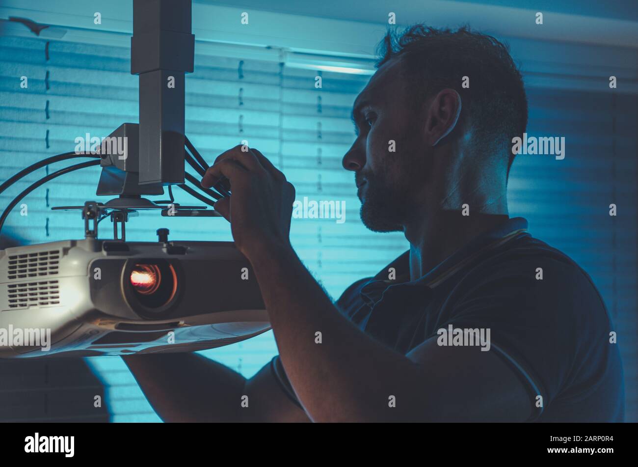 LED Projector Installation and Adjustment by Caucasian Men. Modern Home