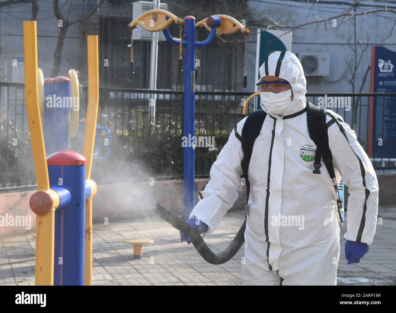 (200129) -- BEIJING, Jan. 29, 2020 (Xinhua) -- A staff member disinfects public fitness equipments at a community in Haidian District in Beijing, capital of China, Jan. 29, 2020. Haidian District of Beijing has carried out disinfection work with the help of professional staff at residential communities to curb the spread of the novel coronavirus. (Xinhua/Ren Chao) Stock Photo