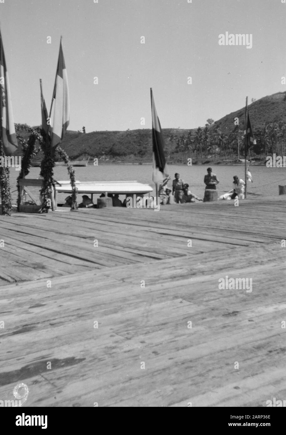 [a boat docks at a jetty with flags] Date 1947/01/01 Location