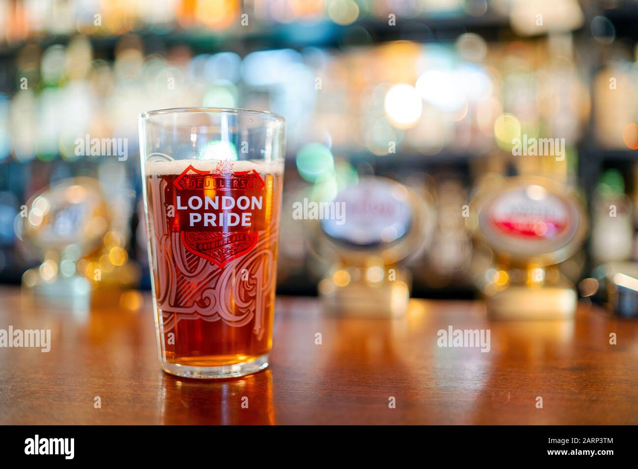 Portsmouth, United Kingdom - November 2, 2019: Glass of cold London Pride beer served in British pub Stock Photo