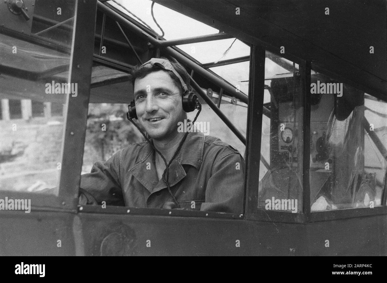 Flyman poses in Piper L-4J Cub Grashopper [see photonr. 5895, 5902, .5903] Annotation: Registration number: PC4-006. and was transferred to the Indonesian Air Force (AURIS) in 1950. Date: 1946 Location: Indonesia, Dutch East Indies Stock Photo