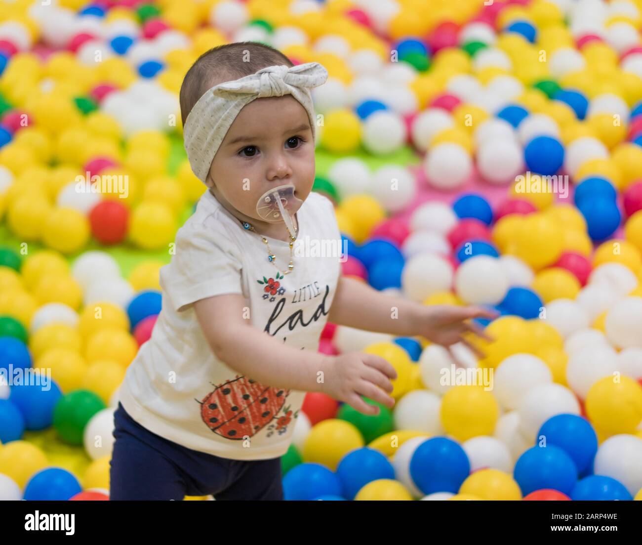 a cute little girl playing in the indoor playground in a shopping centre. Stock Photo