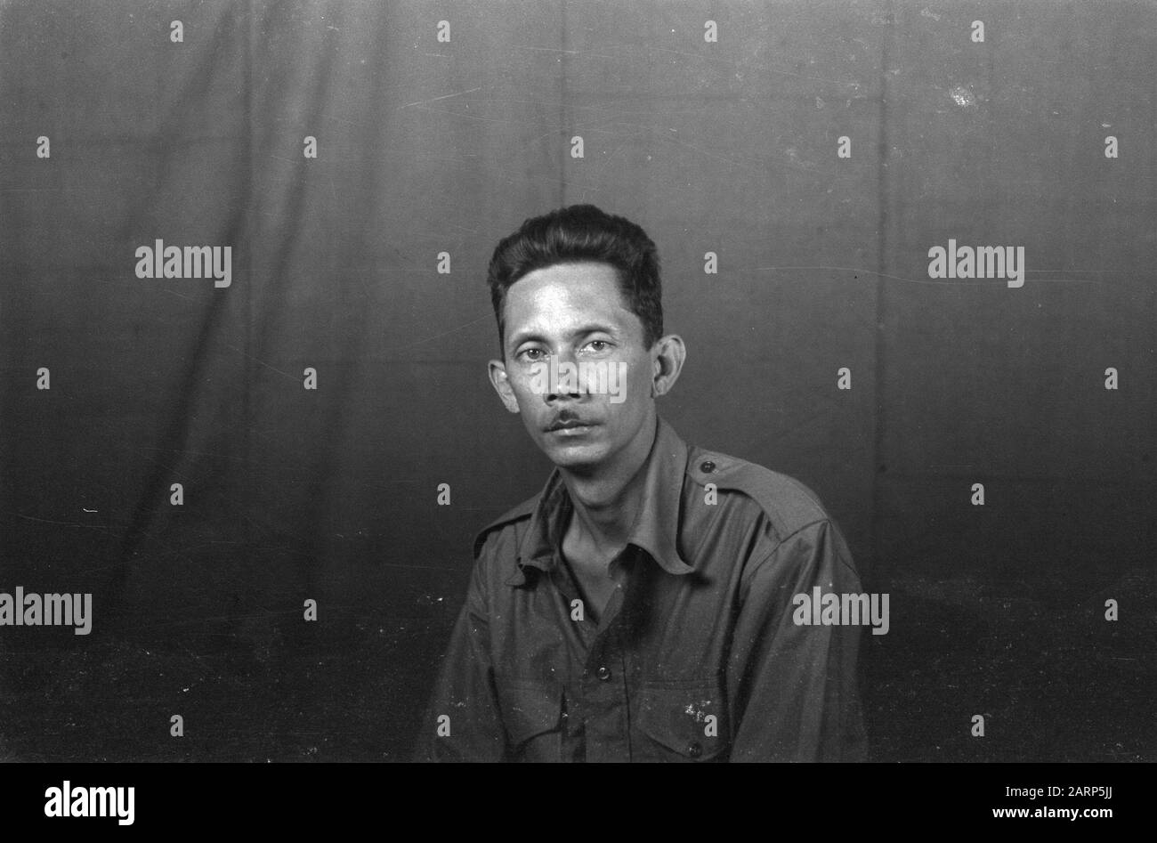 Portrait photos (miscellaneous) [passport photos]  Indian man in uniform with glasses Date: 1947/01/01 Location: Indonesia, Dutch East Indies Stock Photo
