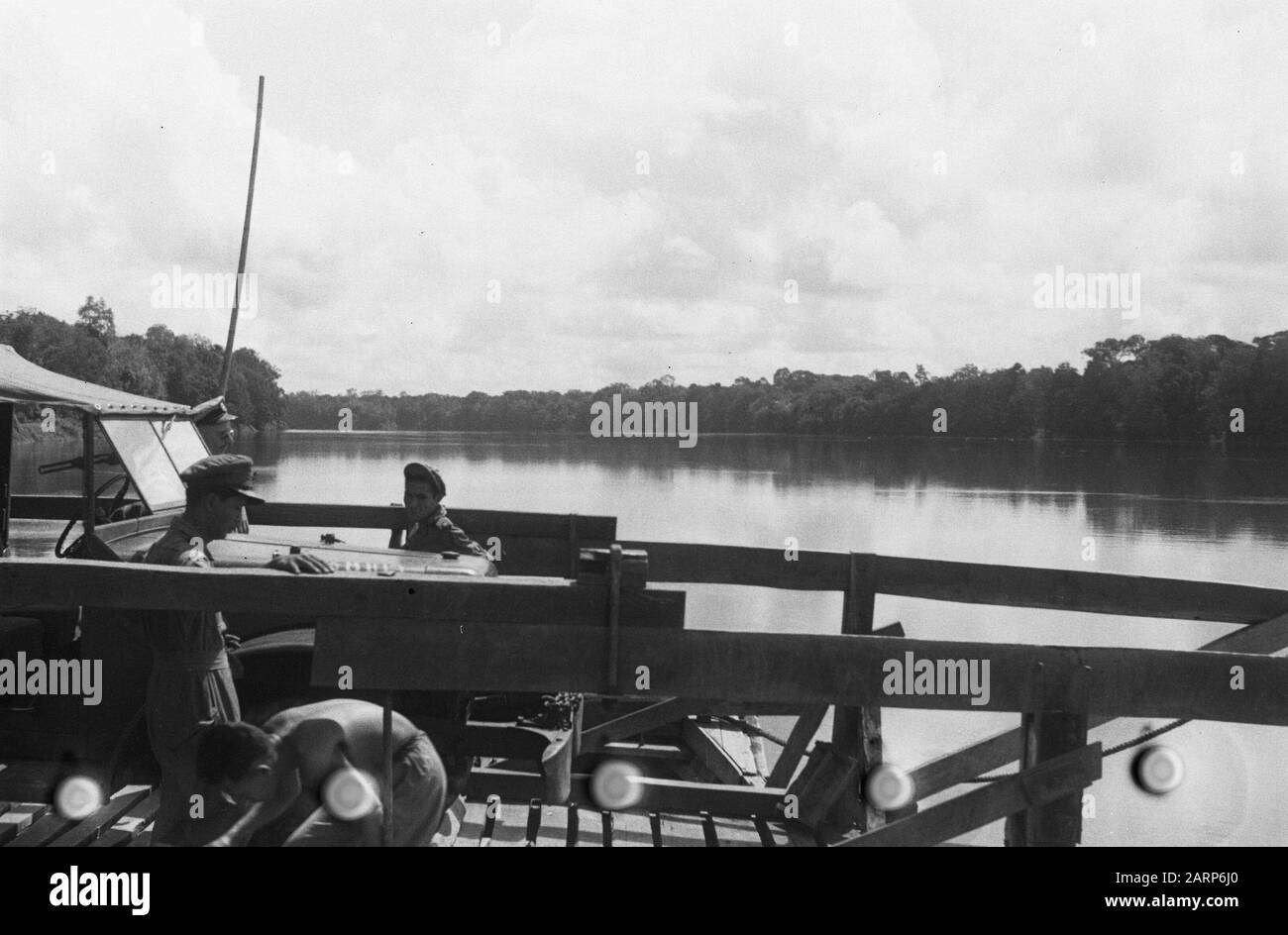 Ferry over river, with jeep Date: 1947/01/01 Location: Indonesia, Dutch East Indies Stock Photo