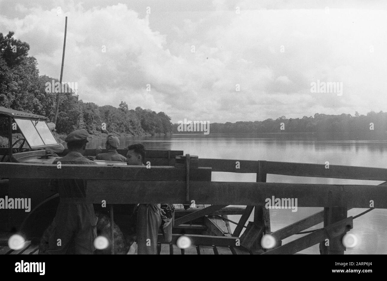 Ferry over river, with jeep Date: 1947 Location: Indonesia, Dutch East Indies Stock Photo