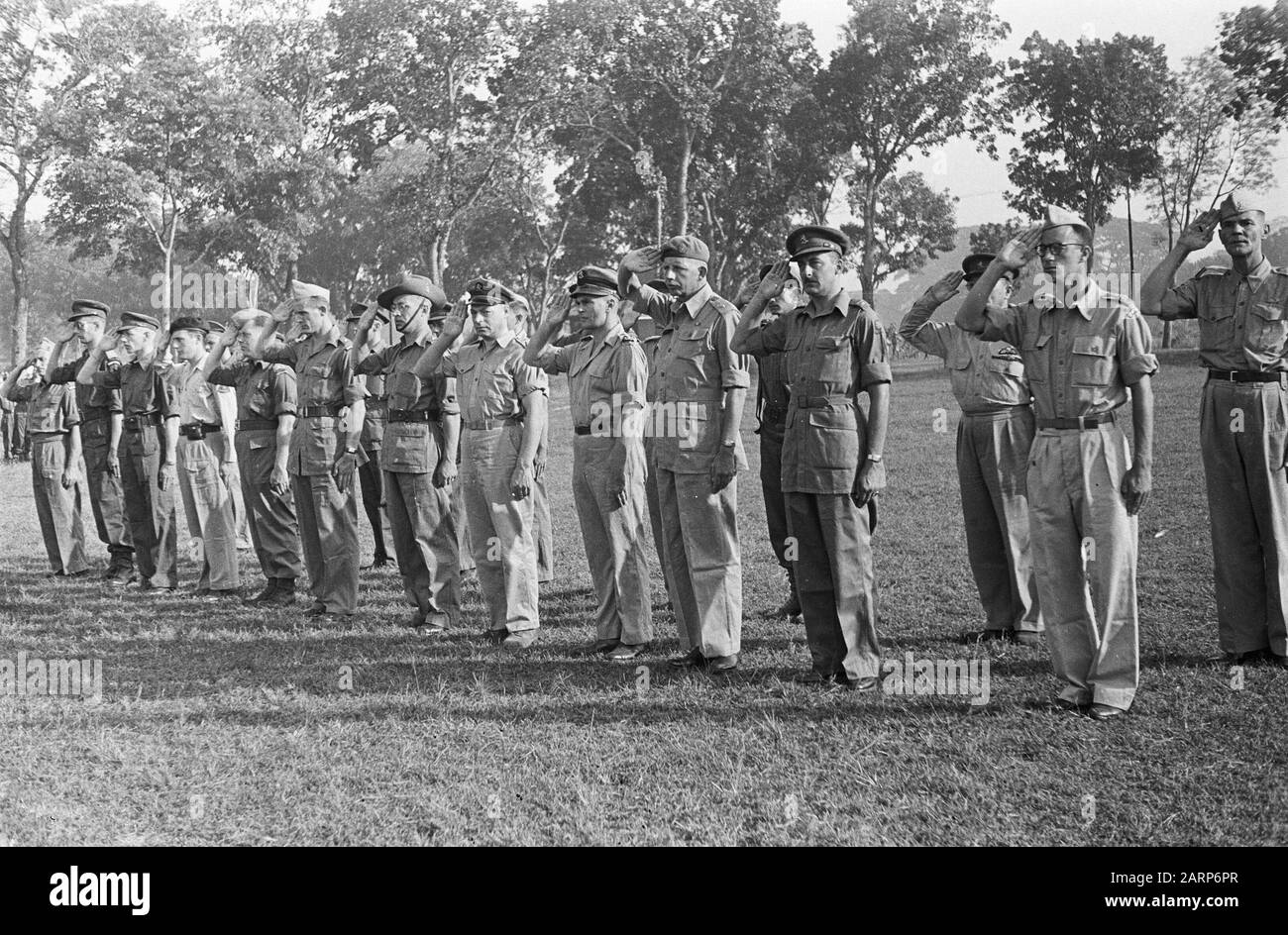 Giving Bronze Lion to Sergeant Rijnders  Group of officers salute. 4th of right General P. Alons Annotation: A hero is decorated The battle at the Meuse in May 1940. The daily newspaper: publication of the Nederlandsche Dagbladpress in Batavia. Batavia, 26-07-1946. Seen on Delpher on 30-03-2016, resolver.kb.nl/ resolve?urn=ddd:010897928:mpeg21:a0040 Date: 23 July 1946 Location: Indonesia, Dutch East Indies Stock Photo