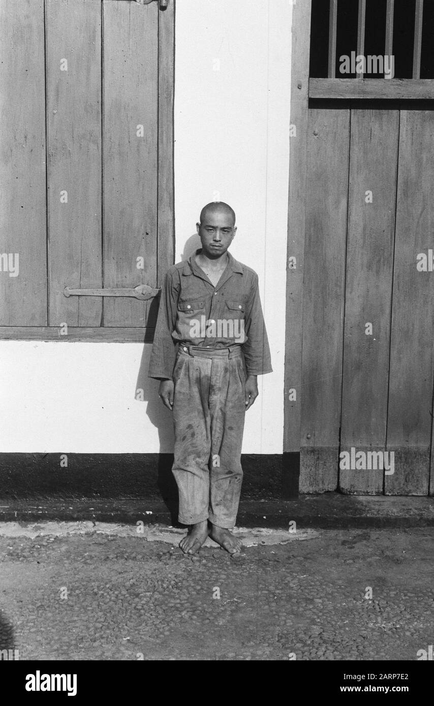 Japanese? Prisoner of war stands in front of a door Annotation: DJK Date: 1947/01/01 Location: Indonesia, Dutch East Indies Stock Photo