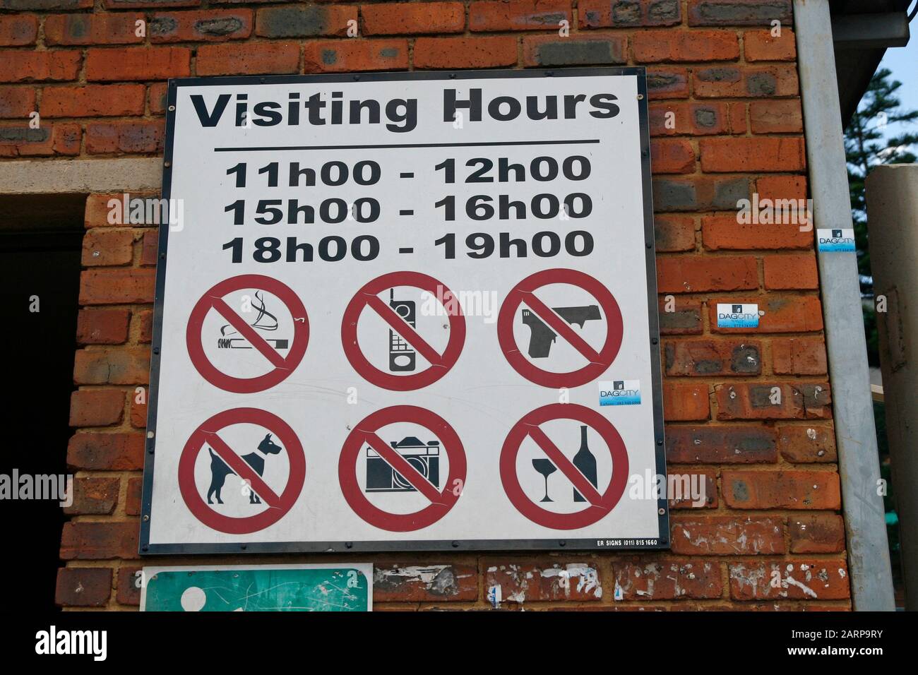 Sign with visiting hours and prohibitions next to tuckshop outside Kalafong  Hospital, Atteridgeville, Pretoria/Tshwane, Gauteng, South Africa Stock  Photo - Alamy