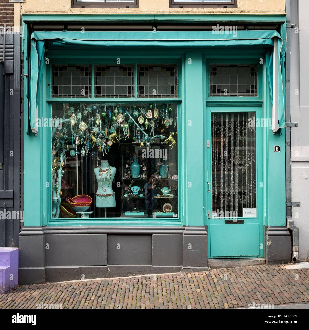 Turquoise Curiosity Shop. The façade to a vintage shop in Dutch town of Nijmegen Stock Photo -