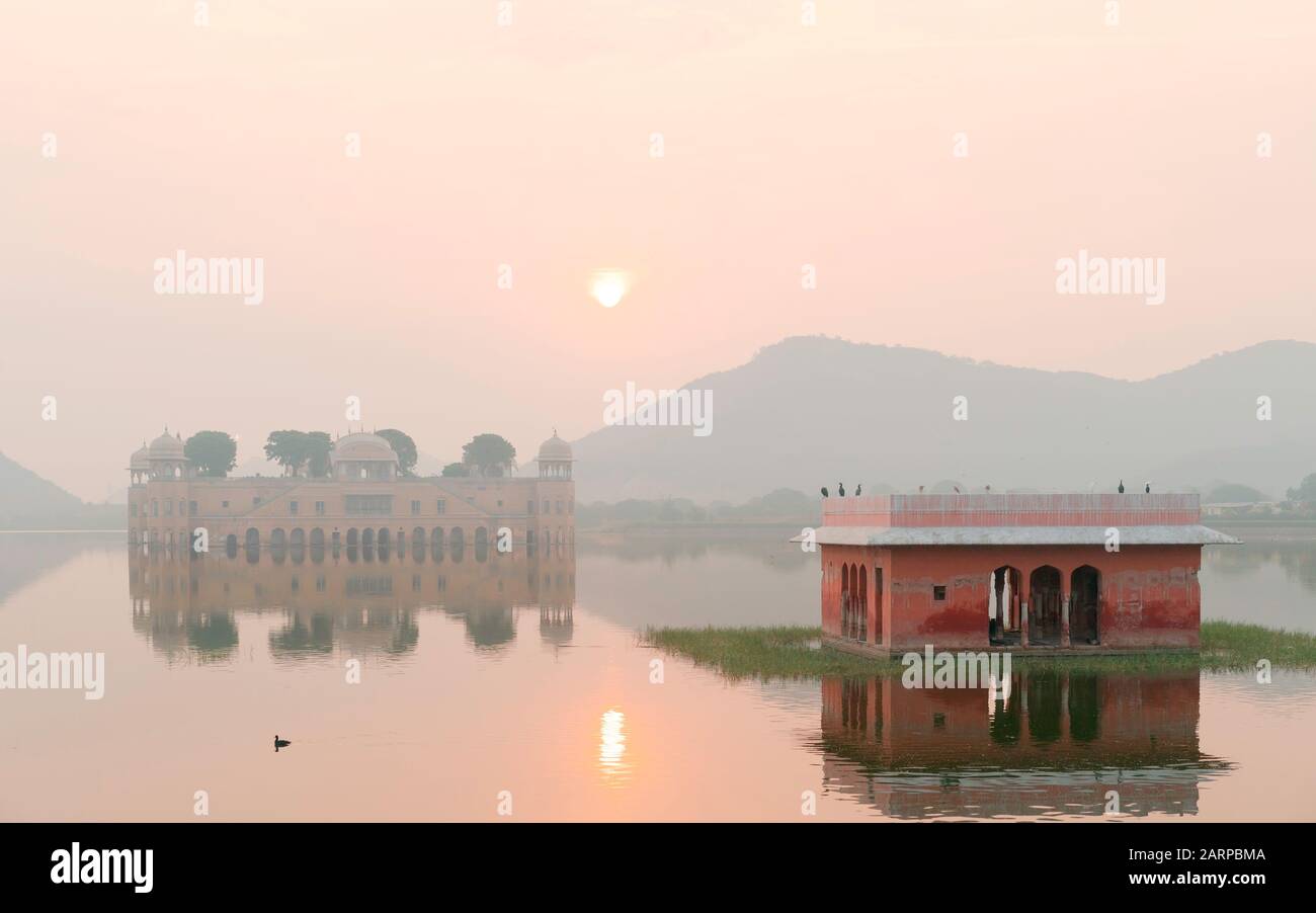 Empty Royal palace surrounded by lake and Aravalli hills as backdrop at sunrise in Jaipur, Rajasthan, India. Stock Photo