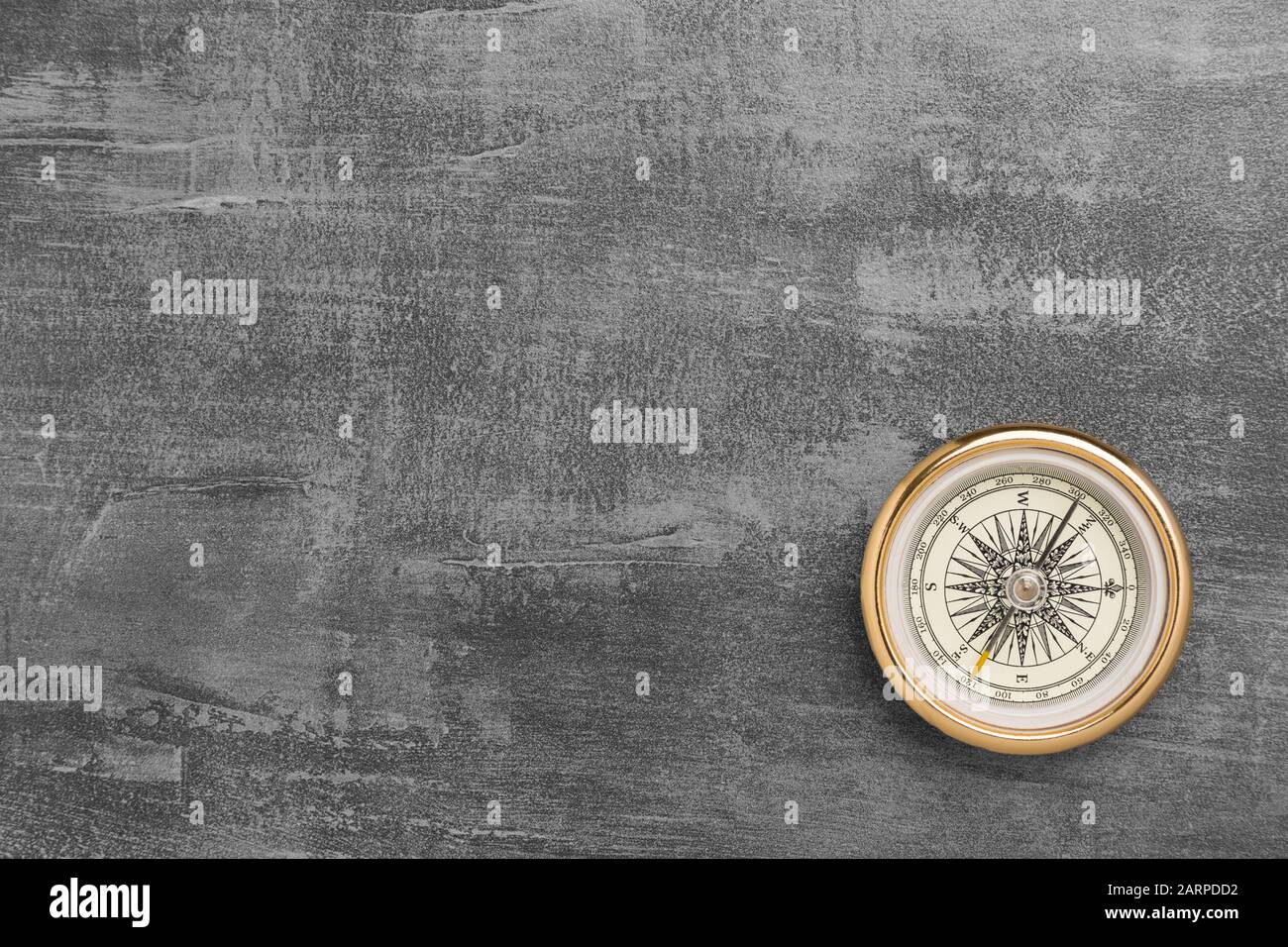 Golden navigational compass on a vintage gray background Stock Photo ...