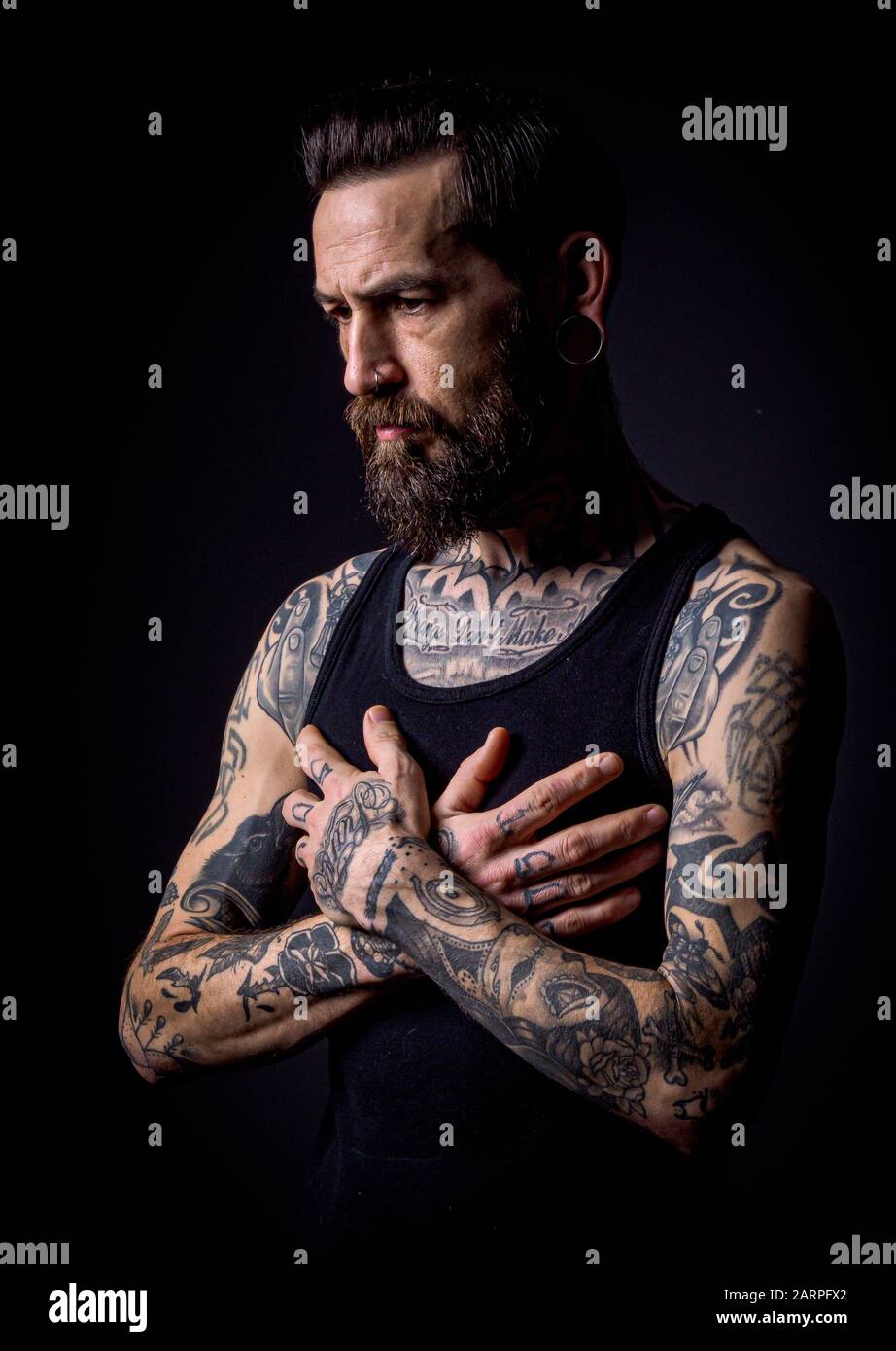 A Muscular Tattooed Man on a Dark Background Stock Photo  Image of chest  adult 149114554