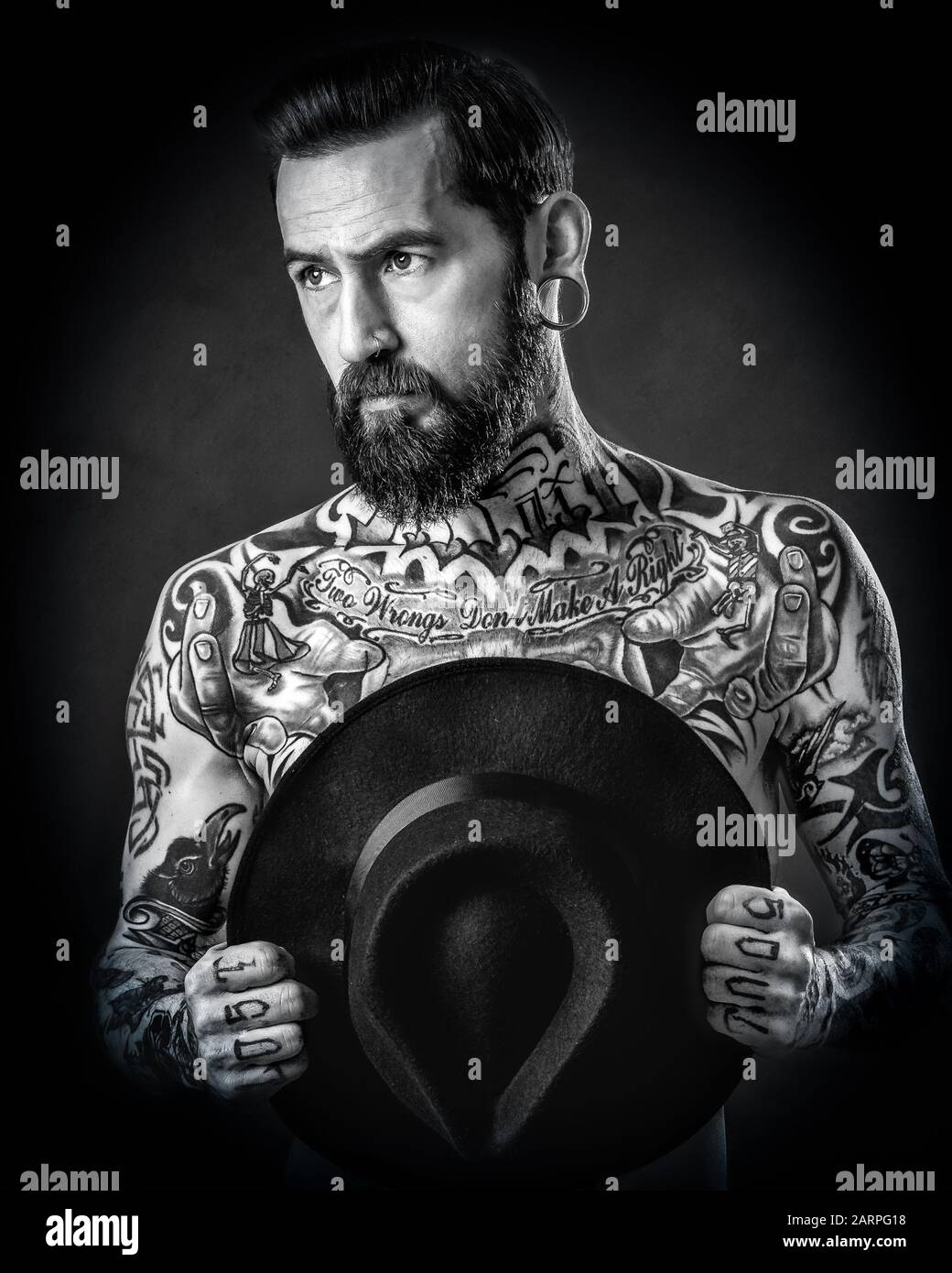 Studio Portrait of a male model with beard and tattoos Stock Photo