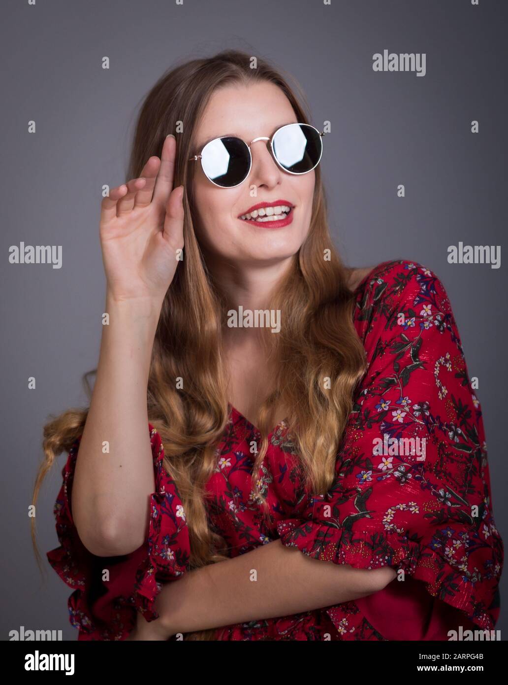 Young woman posing in retro 70's outfits in studio setting Stock Photo