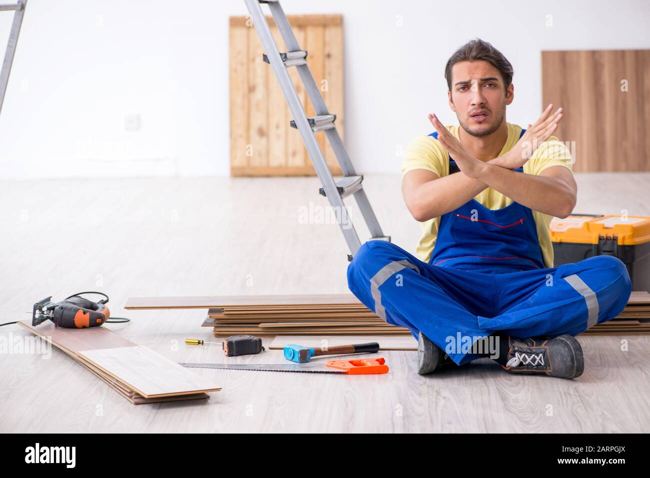 The young male contractor working indoors Stock Photo - Alamy