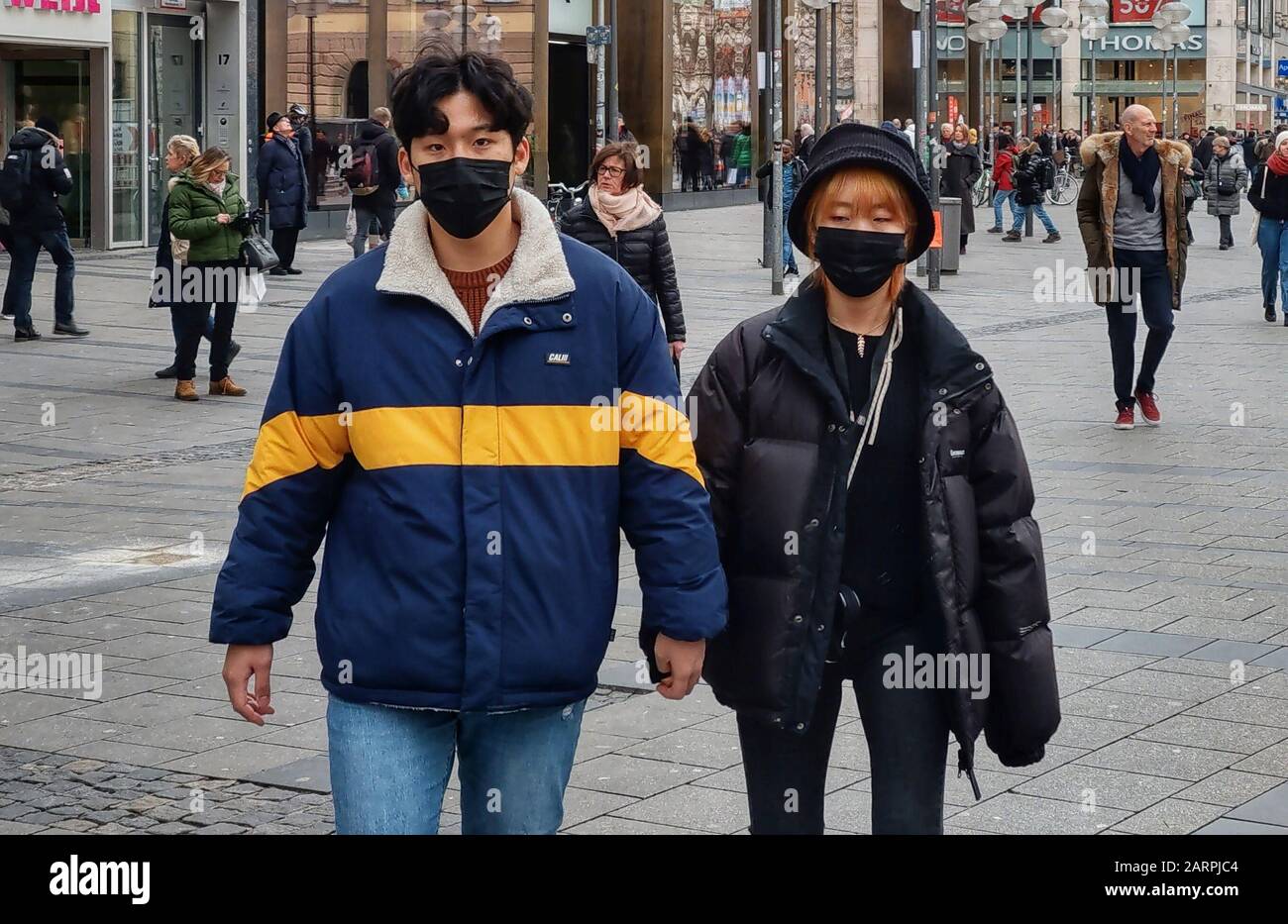 Munich, Bavaria, Germany. 29th Jan, 2020. Two people are among the increasing number of tourists and residents of the city of Munich, Germany wearing breathing masks on the streets in response to Germany's first case of Corona Virus in nearby Starnberg. The affected was infected by a Chinese coworker visiting from Shanghai and is currently at Klinikum Schwabing in Munich. Credit: Sachelle Babbar/ZUMA Wire/Alamy Live News Stock Photo