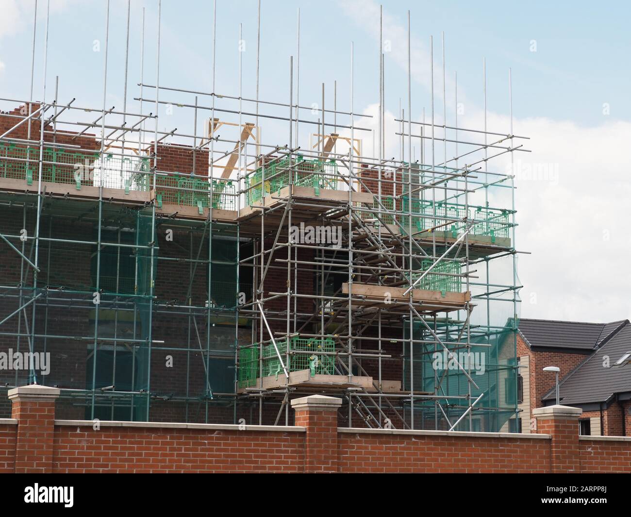 some new flats, apartments being built showing brickwork and scaffolding Stock Photo