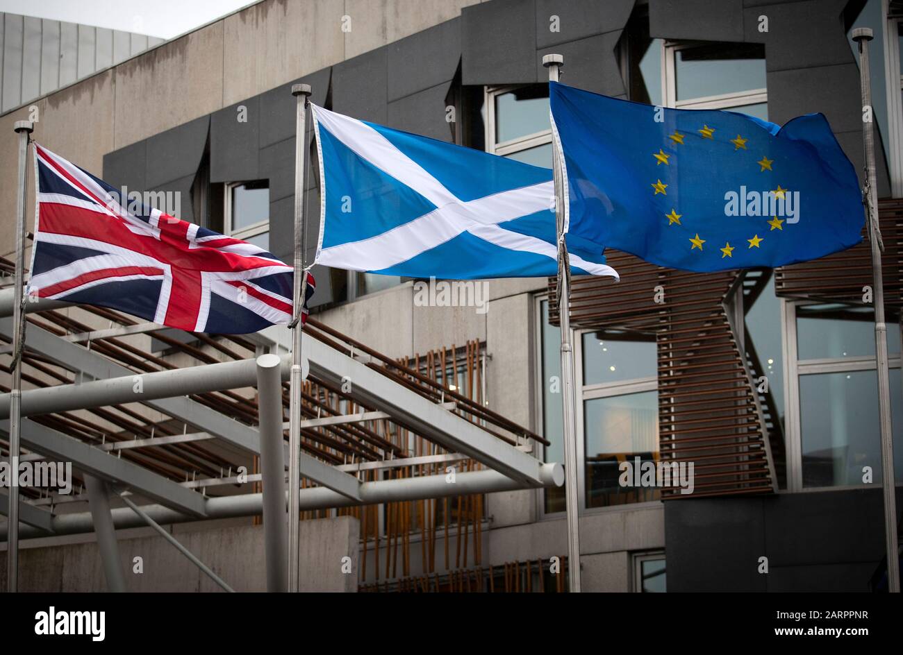 The Union flag, Saltire and EU flag fly outside the Scottish Parliament in Edinburgh. Today MSPs vote on whether or not the EU flag should fly outside the Scottish Parliament building in Edinburgh after Brexit Day on Friday January 31. Stock Photo