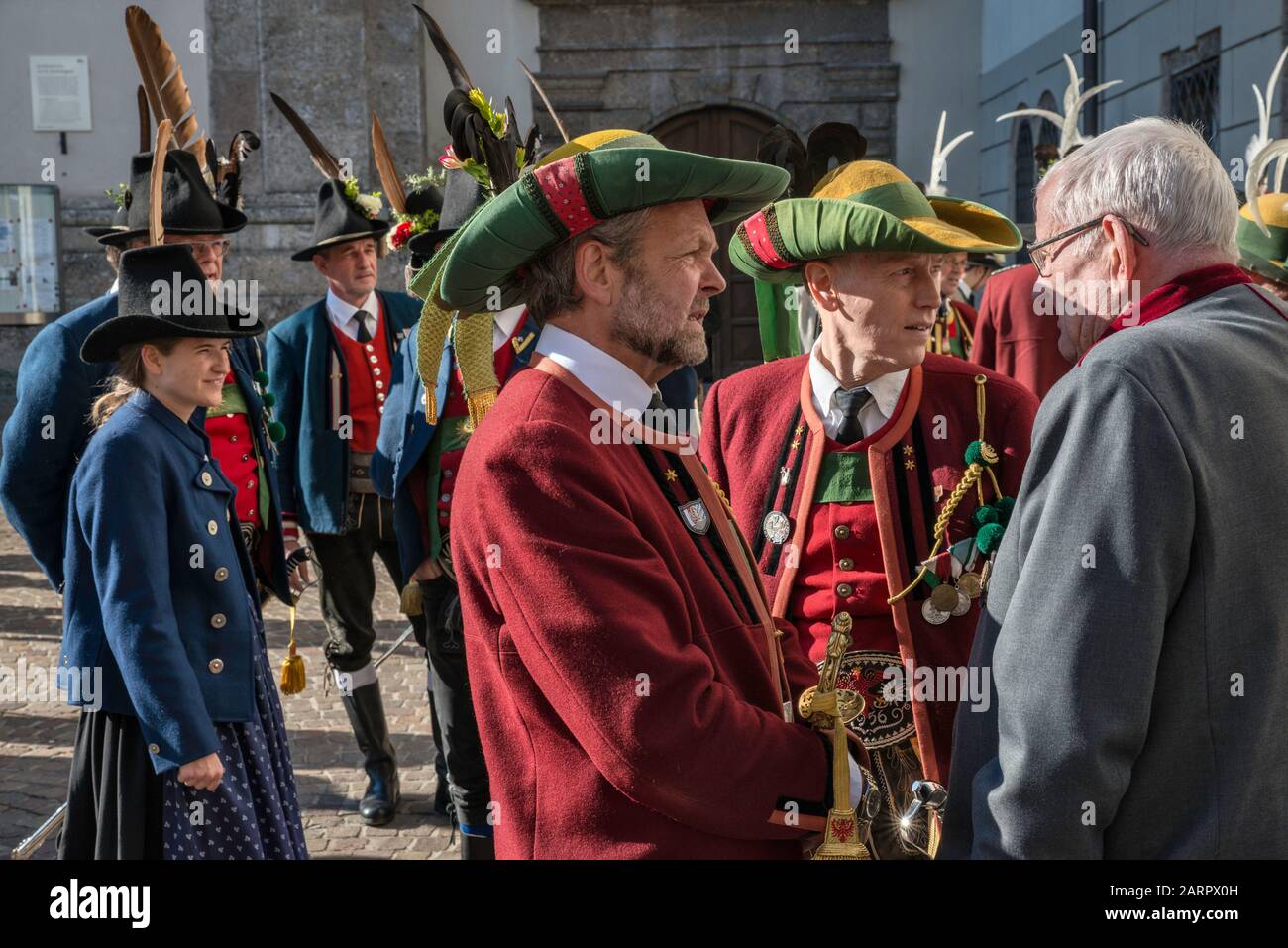 People wearing traditional Tyrolean clothes, in front of Jesuit Church (Jesuitenkirche) aka University Church, Innsbruck, Tyrol, Austria Stock Photo