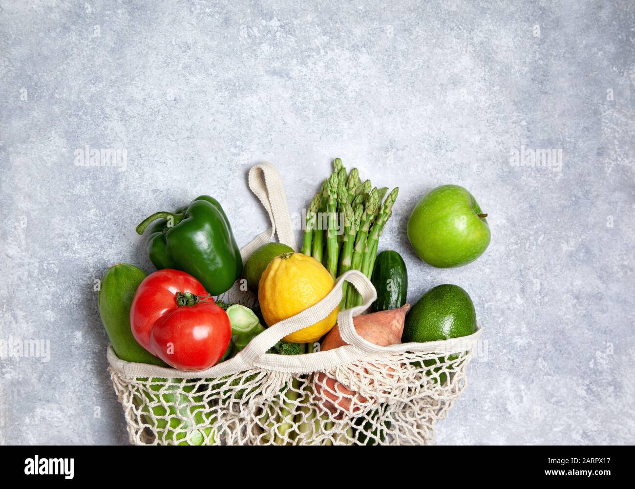 Zero waste and eco friendly shopping. Eco friendly mesh bag with organic fruits and vegetables