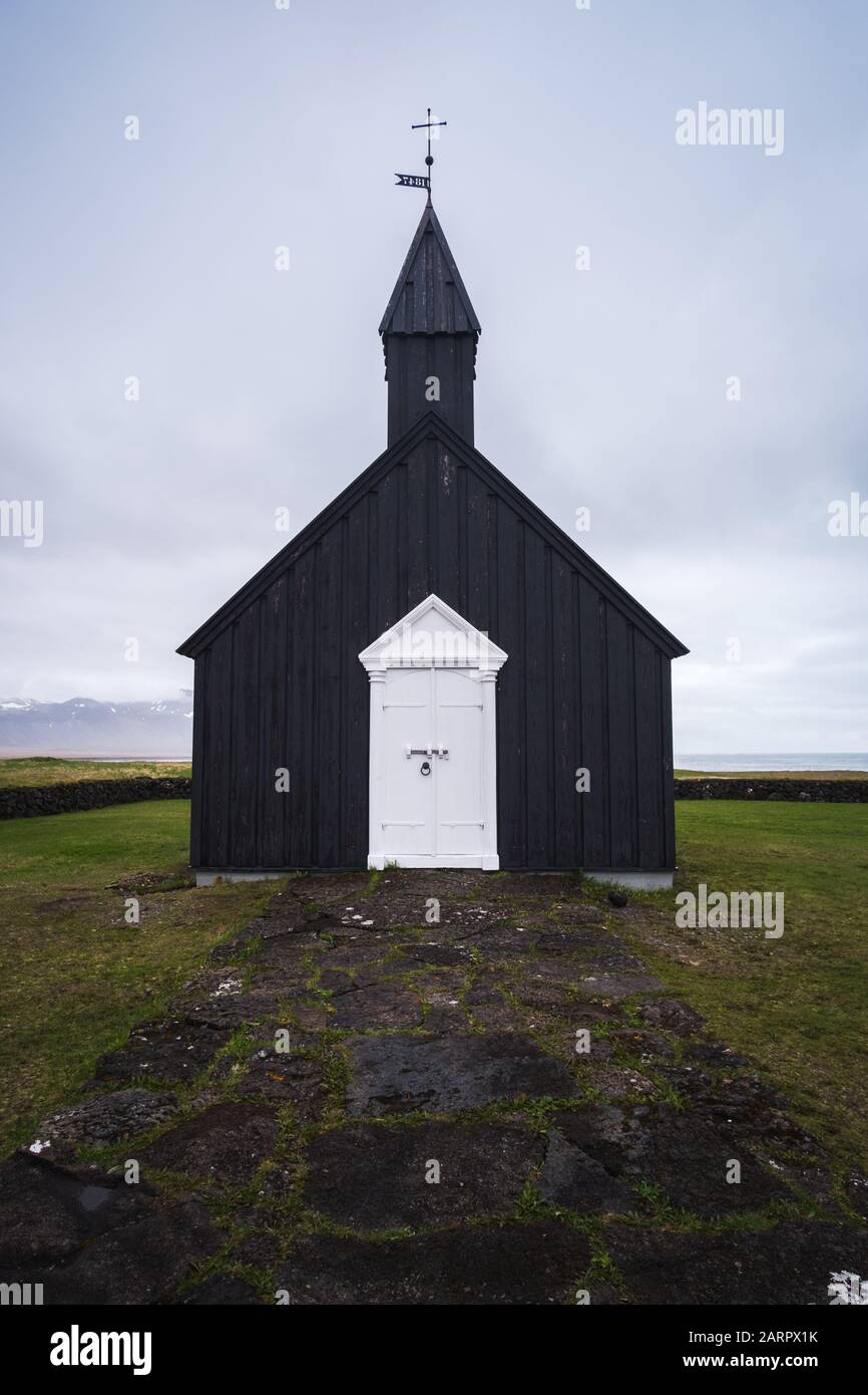 Búðakirkja, the coastal black church of Iceland, located on the south coast of Iceland's Snæfellsnes peninsula. Stunning white door and epic overcast Stock Photo