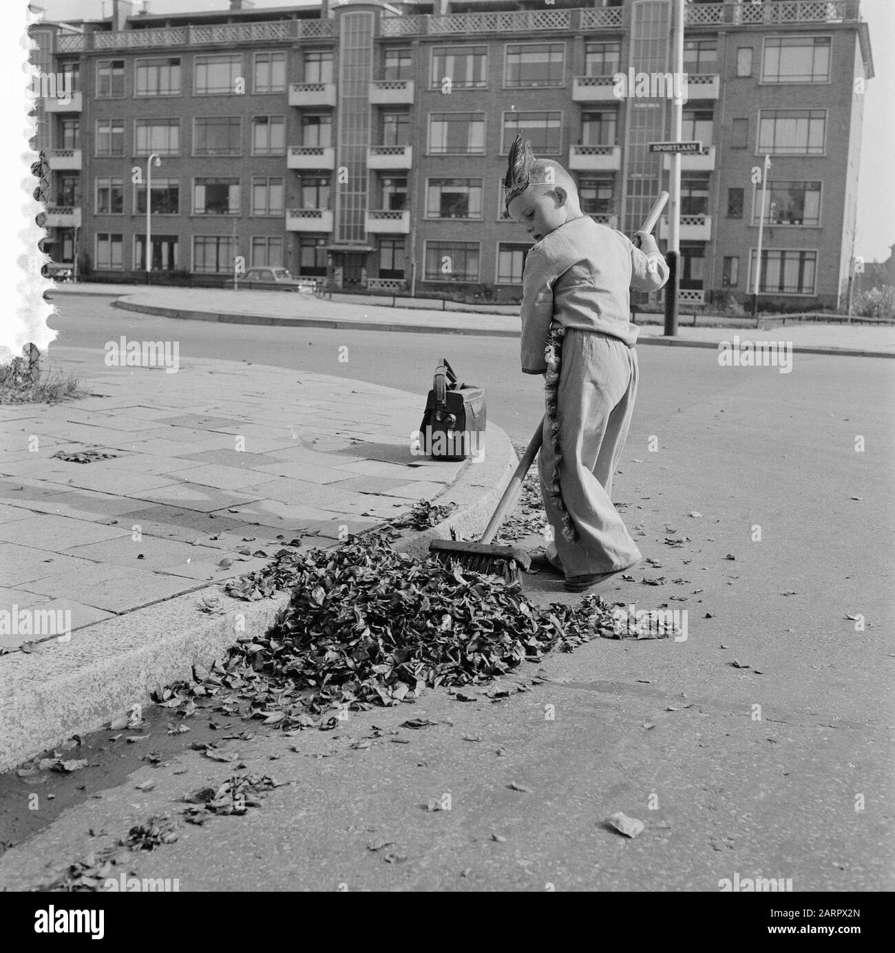 Boy wiping leaves Date: September 26, 1957 Keywords: BROWS Stock Photo