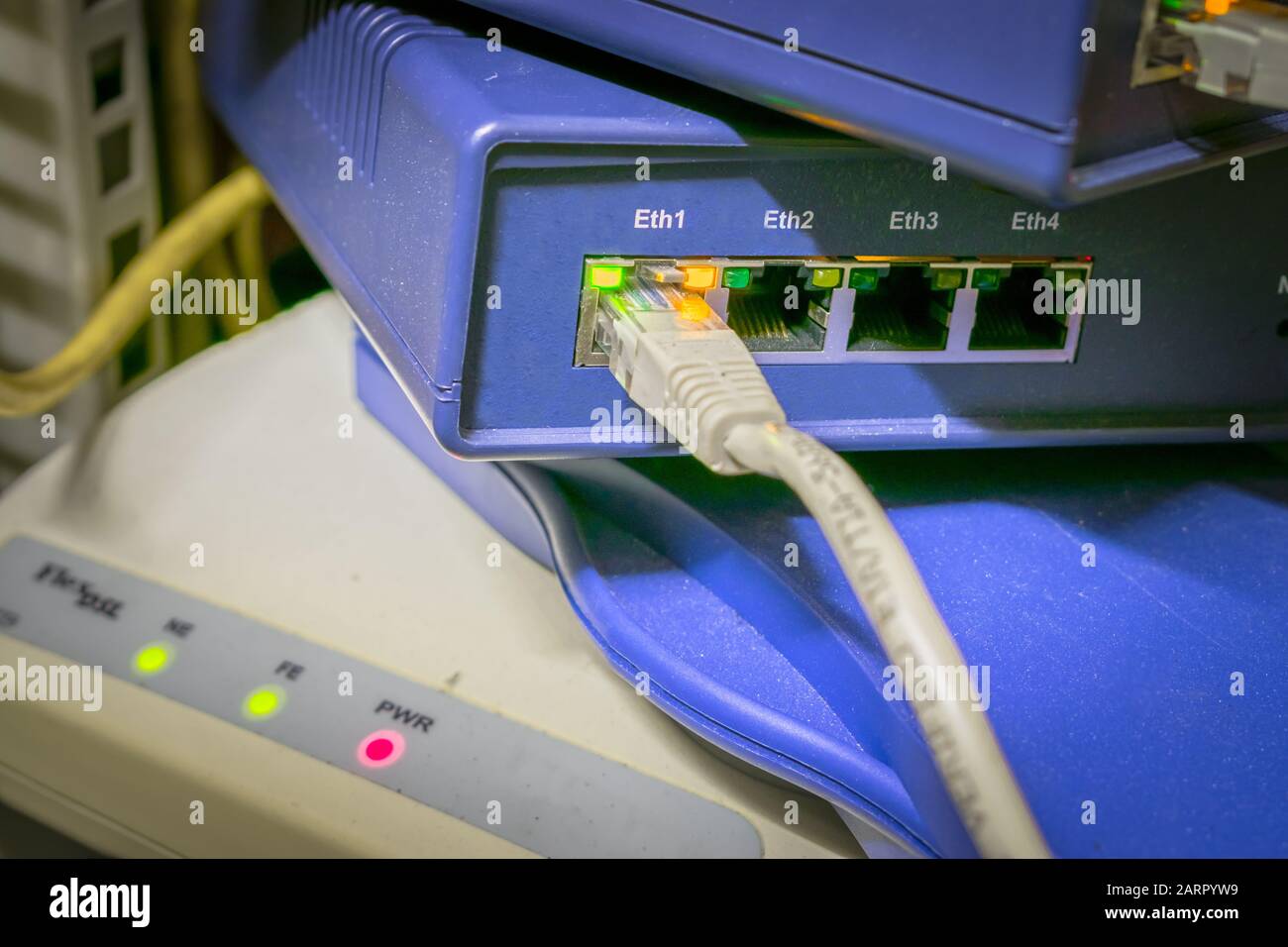 The Internet UTP cable connects to the network interface of the router.  Server cabinet with network Internet equipment Stock Photo - Alamy