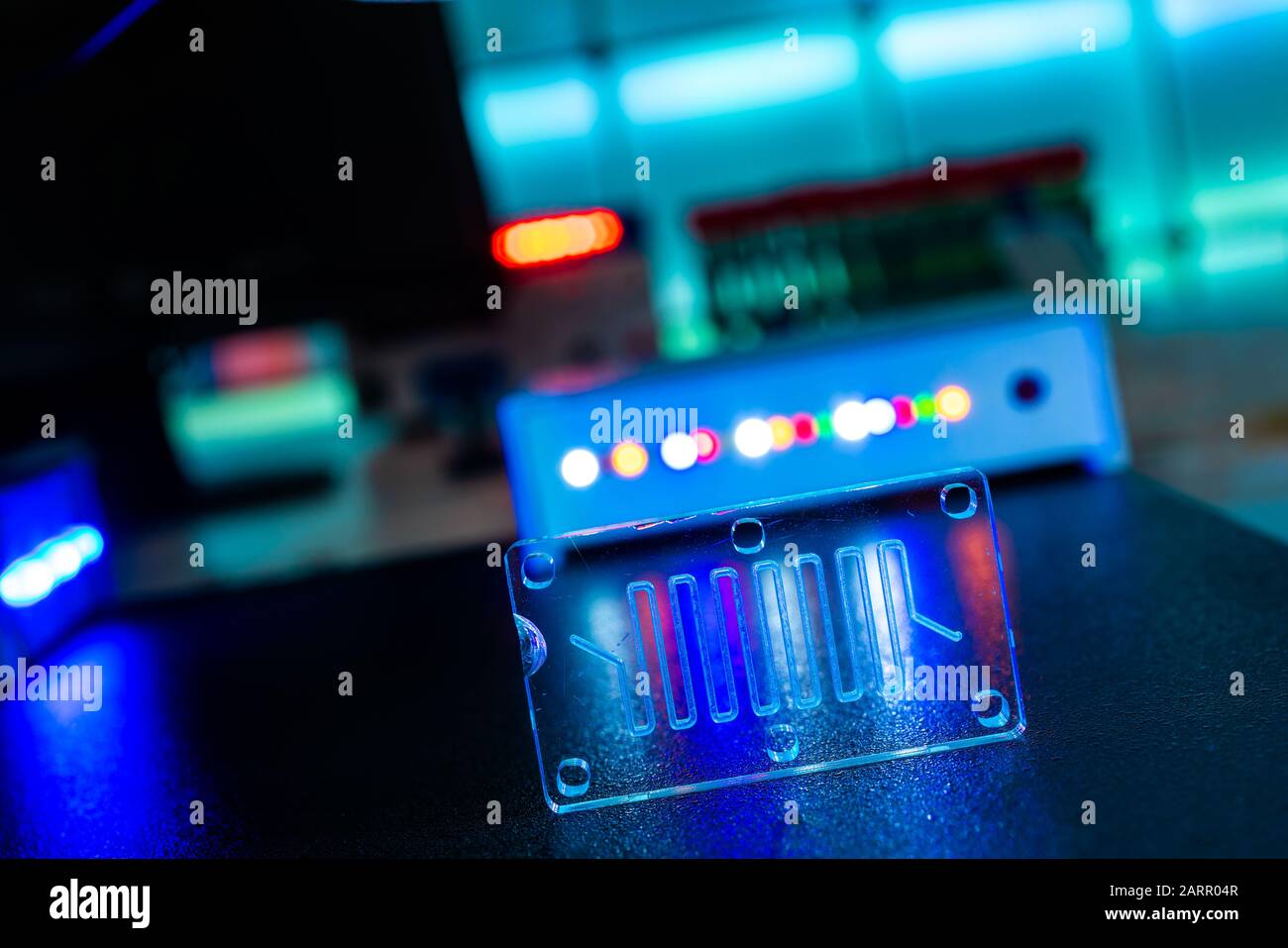 microfluidic device Instrument that uses micro amounts of fluid on a microchip to do certain laboratory tests. Stock Photo