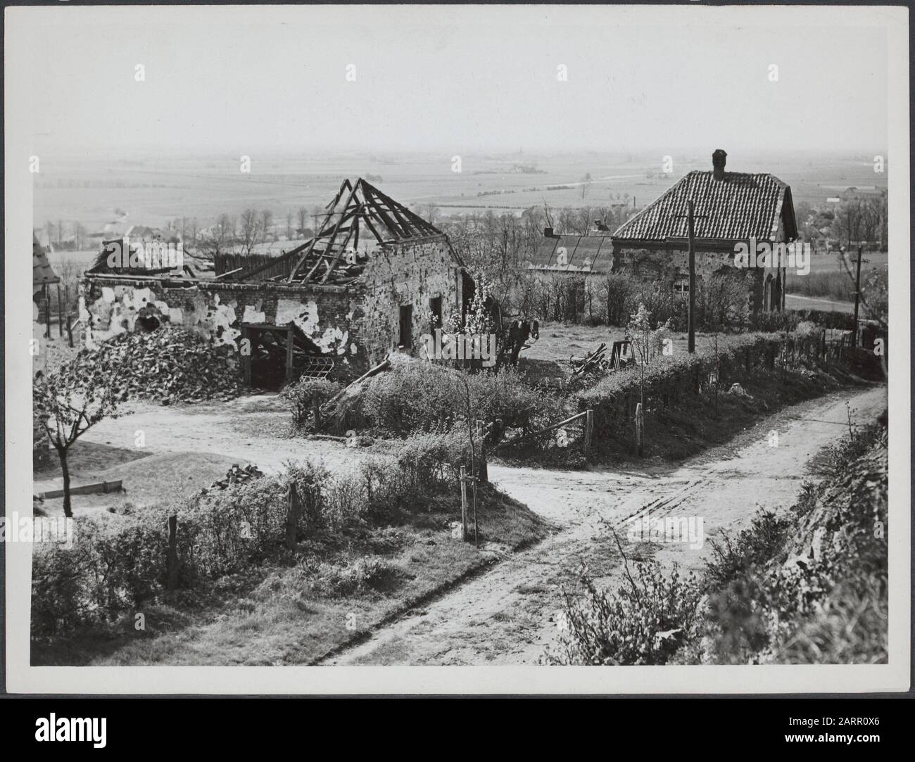 War, liberation and capitulation I  Destroyed farmhouses. Hilly landscape Annotation: Limburg? Date: 1945 Stock Photo