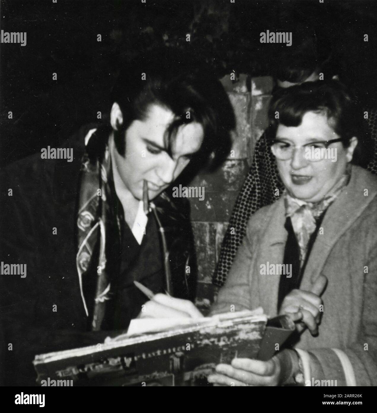 American singer and actor Elvis Presley signing autographs to fans, USA 1950s Stock Photo