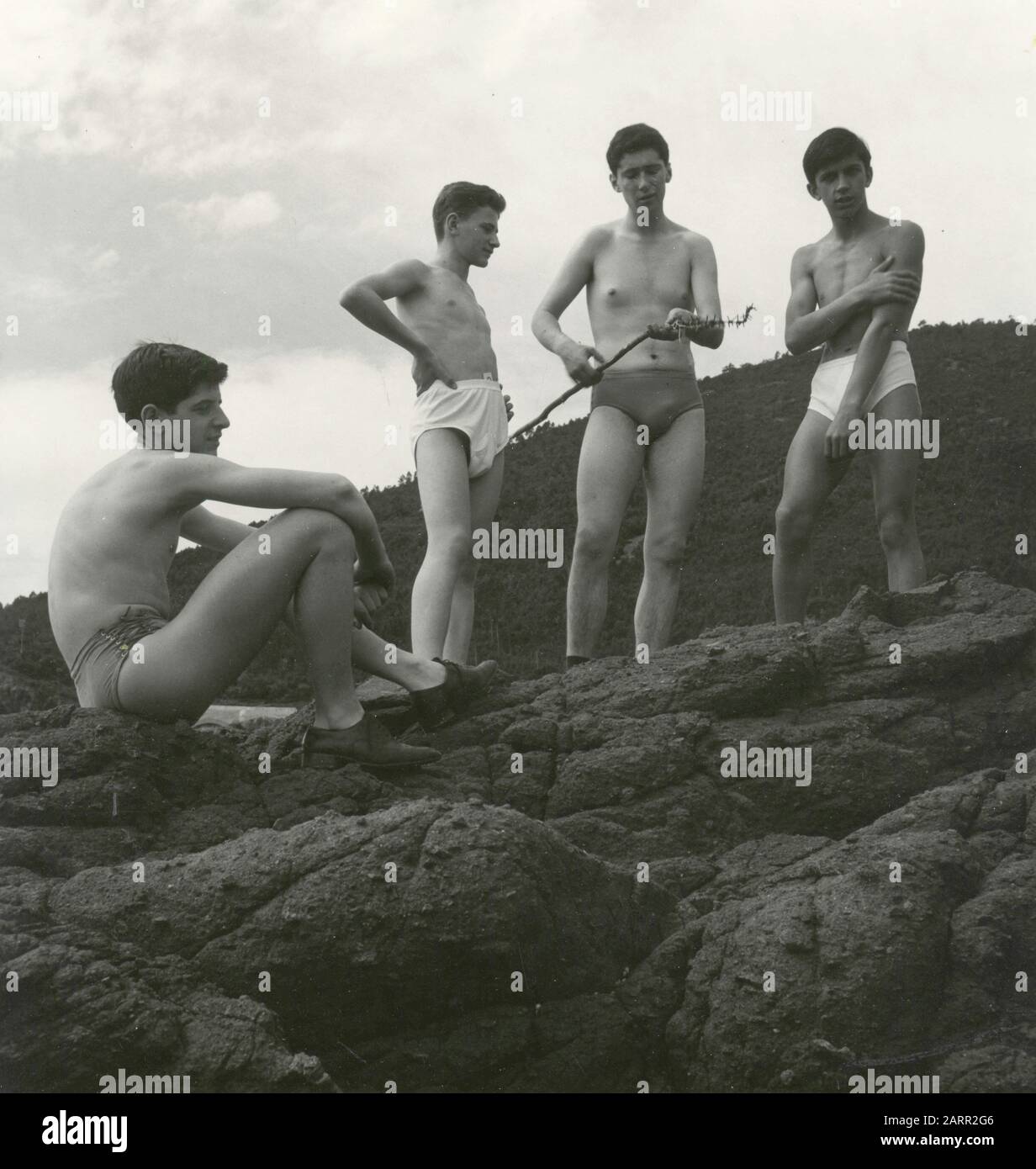 https://c8.alamy.com/comp/2ARR2G6/teenagers-in-underwear-on-a-rock-italy-1960s-2ARR2G6.jpg