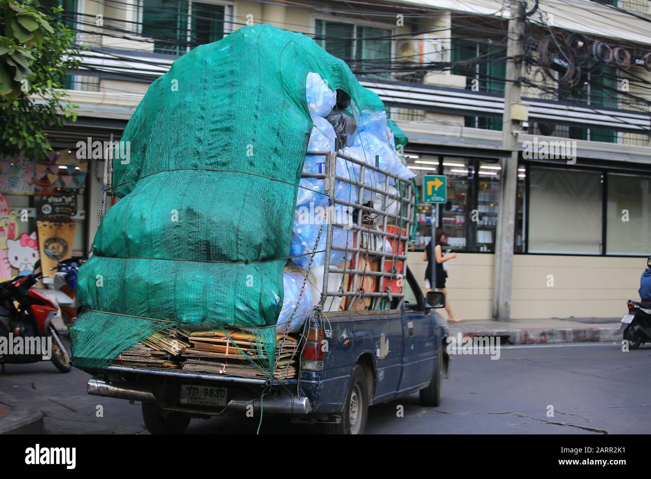 Truck overloaded with plastic containers - Stock Image - C047/7908 -  Science Photo Library