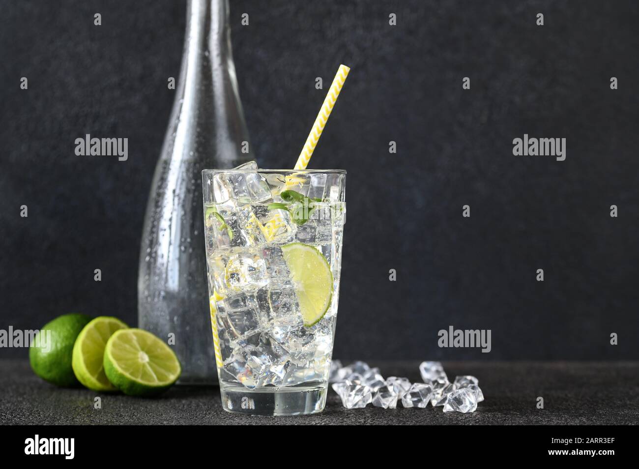 Glass of sparkling water with ice cubes and slice of lime Stock Photo ...