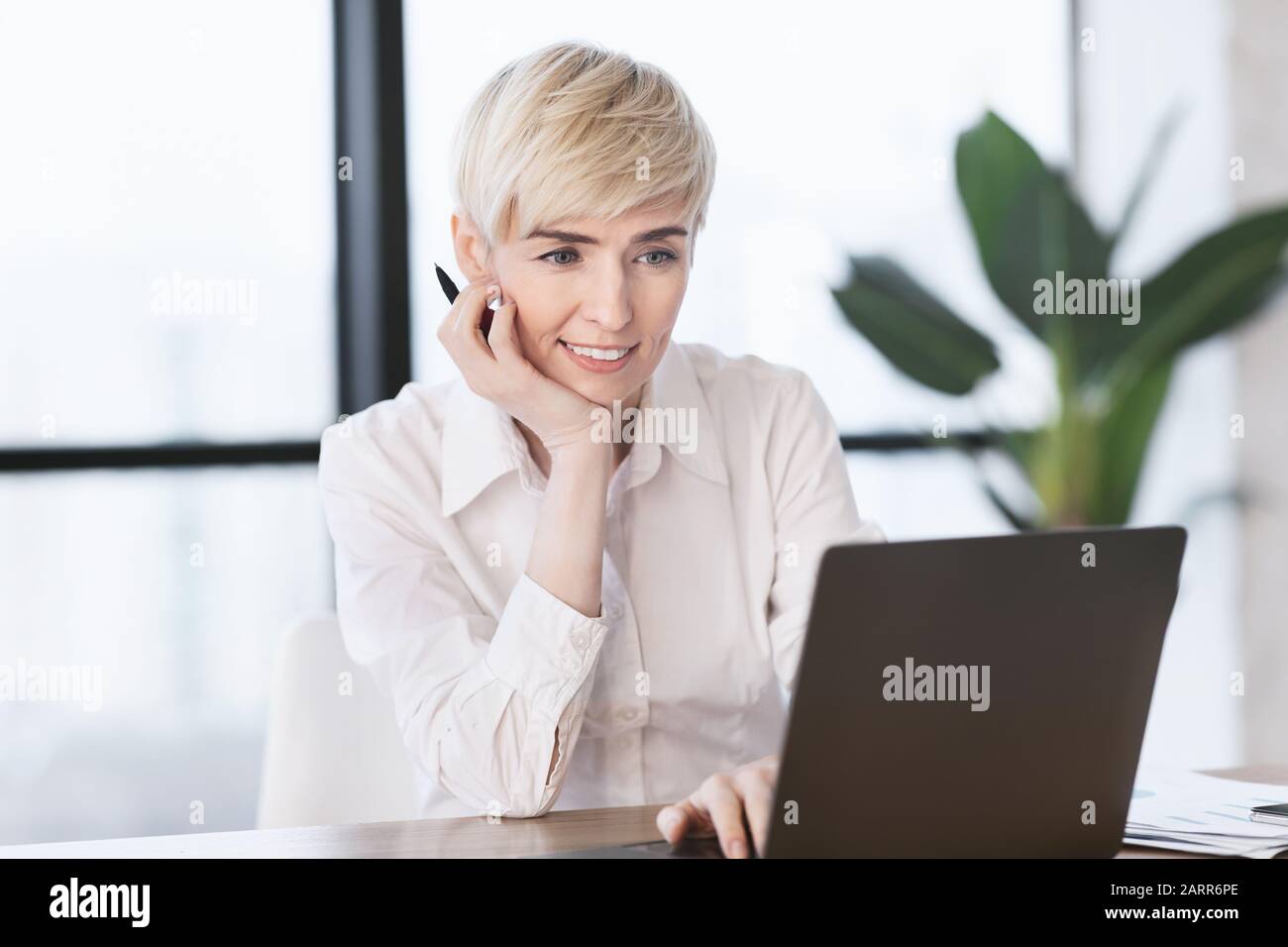 Mature Business Lady At Laptop Computer Working Sitting In Office Stock Photo