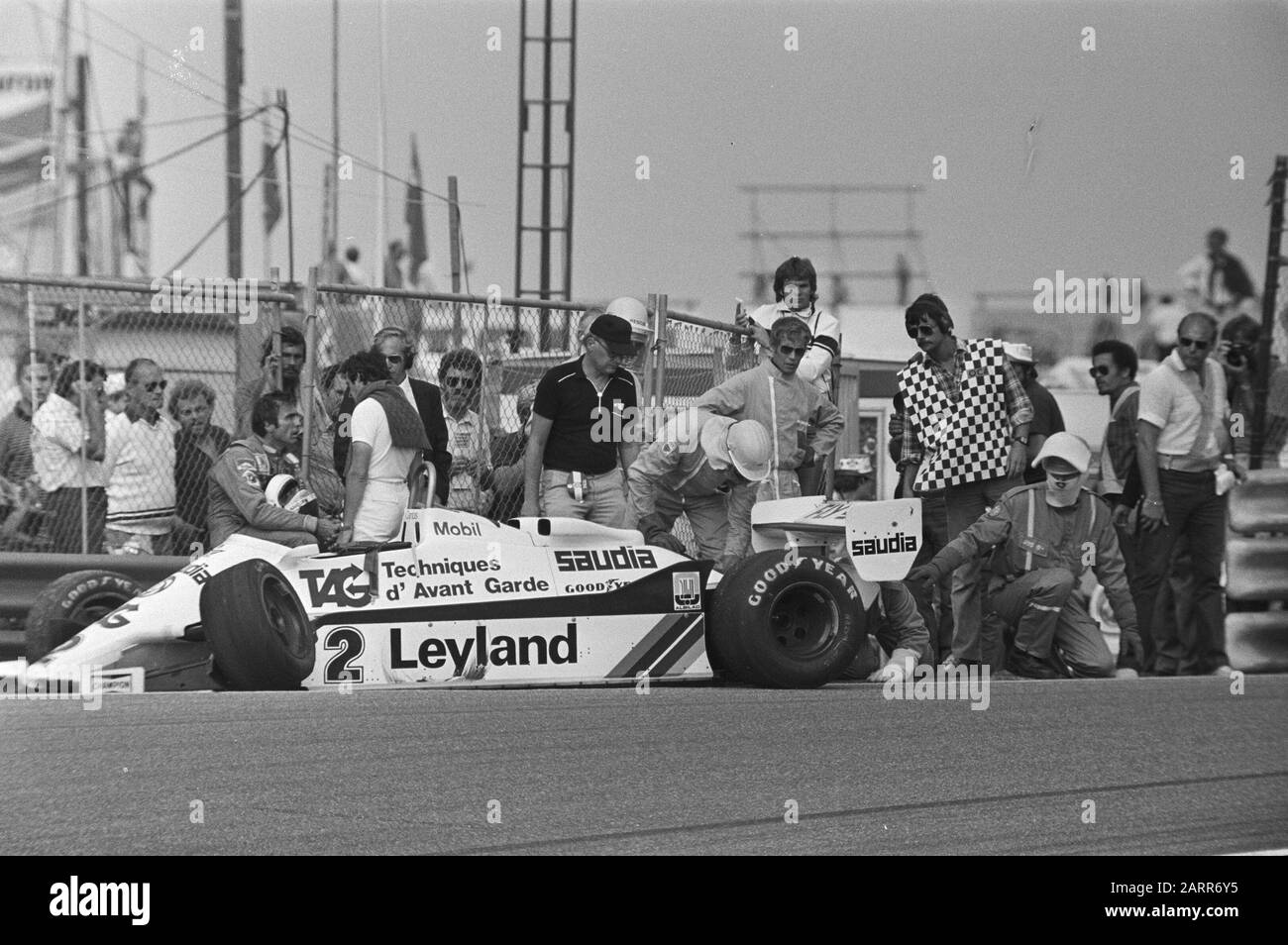 Argentine racing driver Carlos Reutemann (left) next to his Williams-Ford after a collision during the Dutch Formula One Grand Prix, with the OCA rescue team.; Stock Photo