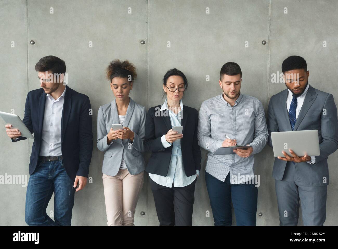 Business and digital world. Diverse team using modern gadgets Stock Photo