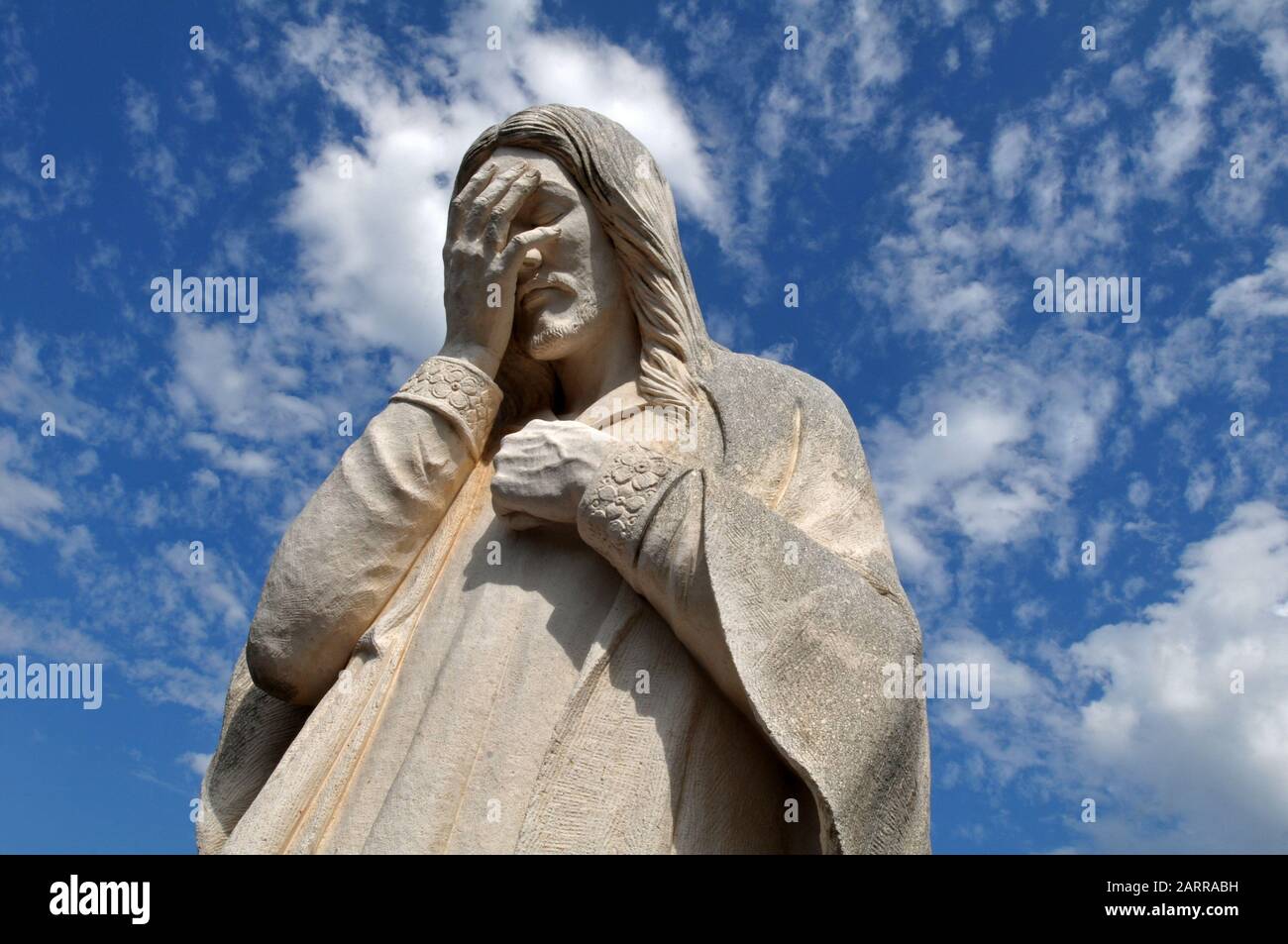The statue 'And Jesus Wept', outside St. Joseph Old Cathedral and across from the site of the 1995 Oklahoma City bombing, pays tribute to those lost. Stock Photo