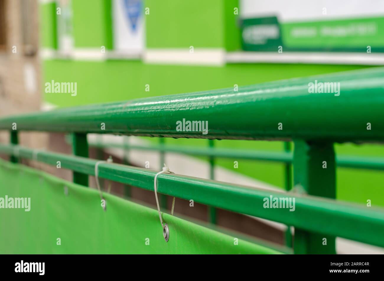 Green railing with raindrops. Fence around the ramp for the disabled ...