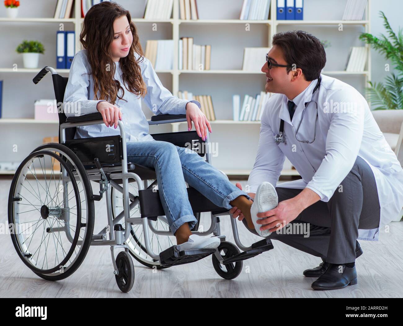 Disabled patient on wheelchair visiting doctor for regular check up Stock Photo Alamy