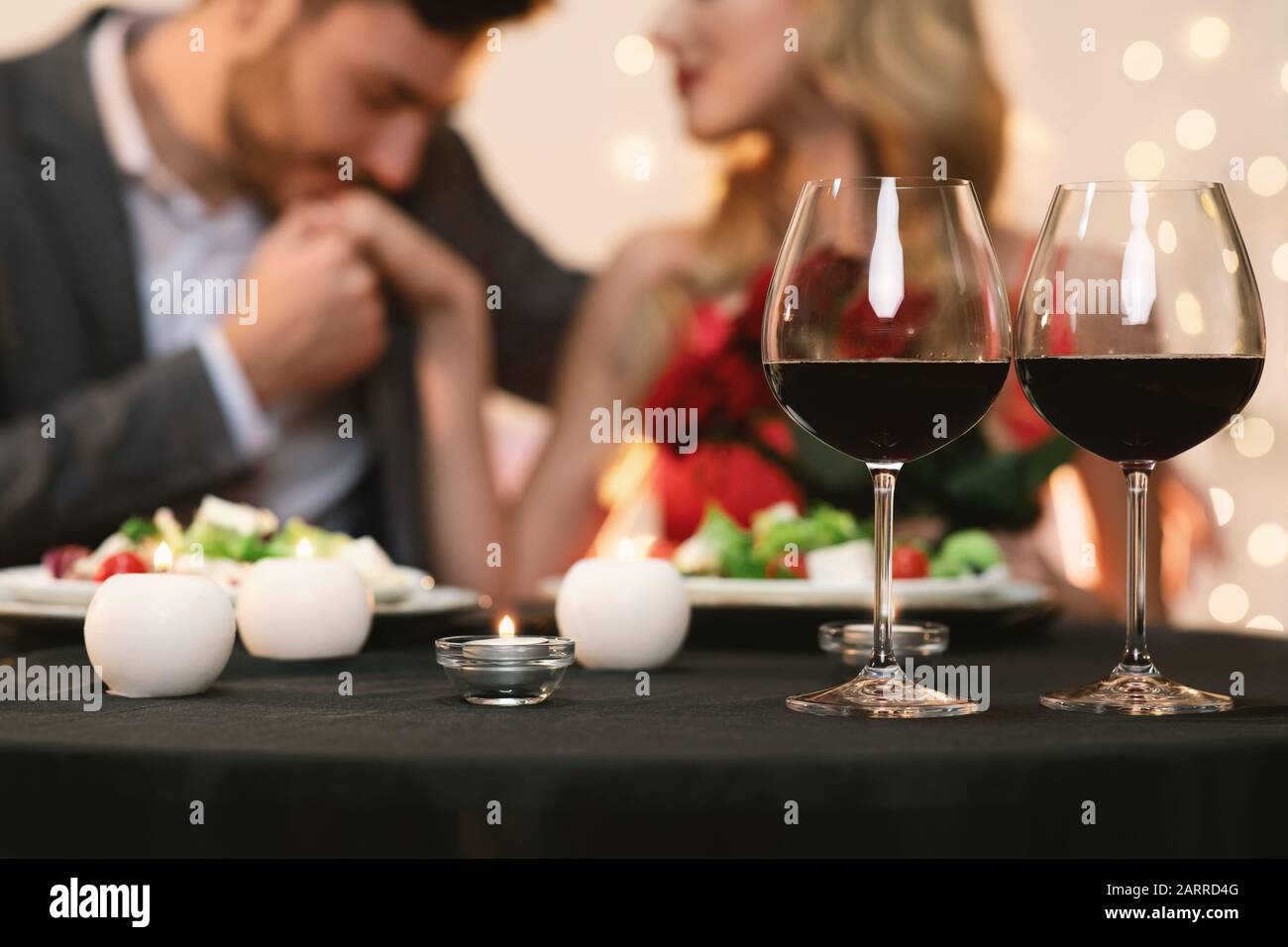 Loving couple in restaurant celebrating Valentine's day together Stock Photo