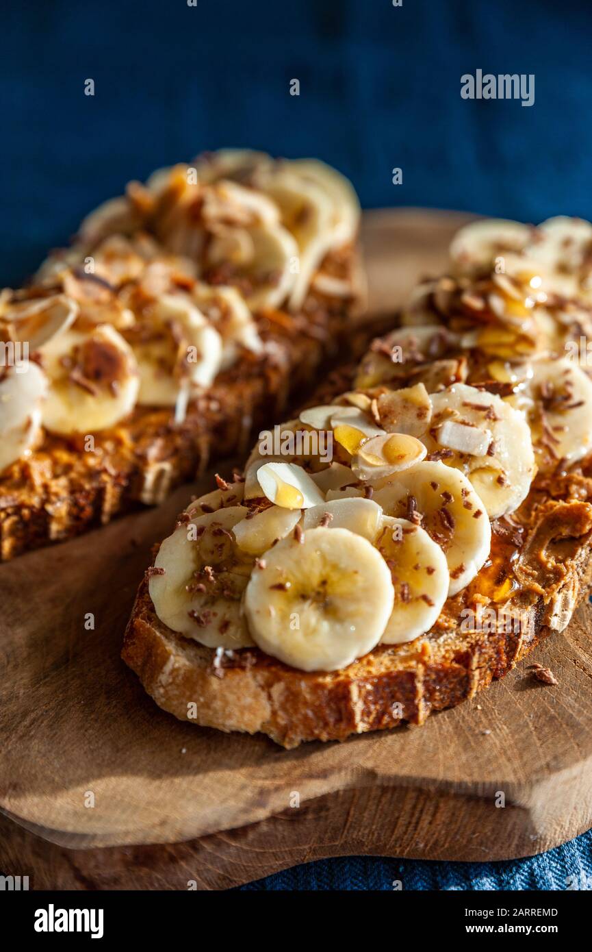 Slices of bread topped with peanut butter, honey and banana slices Stock Photo
