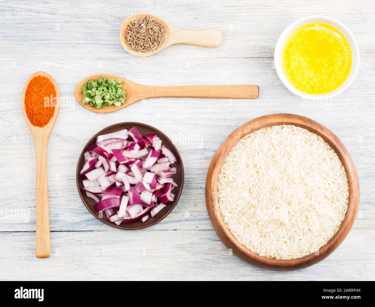 Ingredients for cooking basmati rice butter, onion, cumin (jeera), red chili pepper, masala