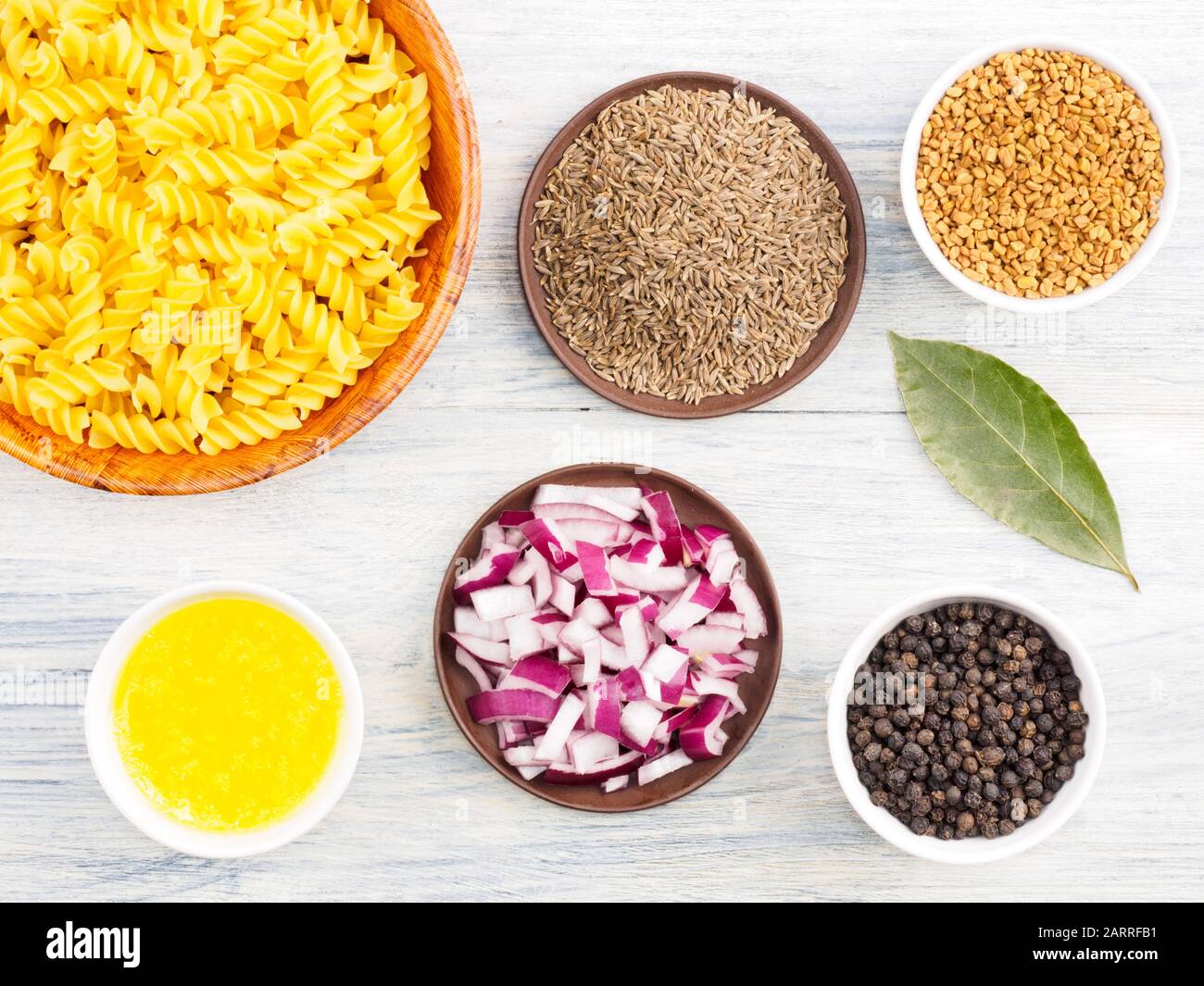 Ingredients for cooking pasta black pepper, onion, bay leaves
