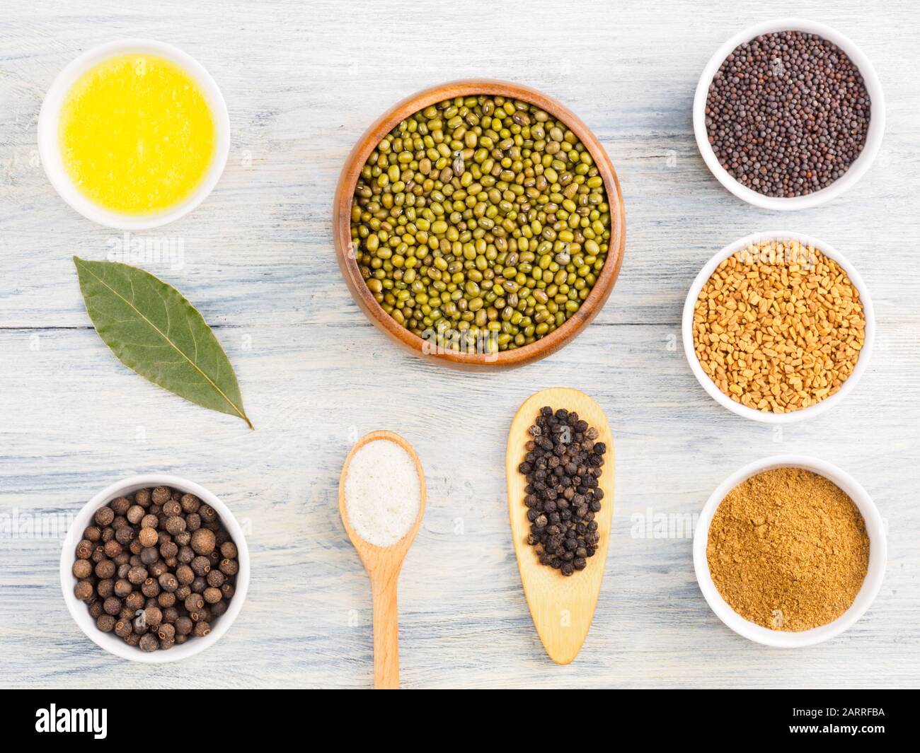 Ingredients for cooking mung bean: butter, allspice, bay leaves, black pepper, masala, fenugreek, mustard seeds. Healthy eating concept Stock Photo