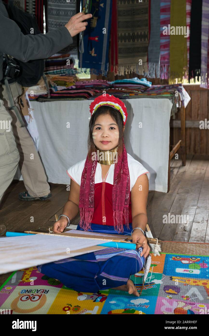 Young woman wearing a traditional heavy brass necklace at Paper factory on Inle Lake,  Myanmar Stock Photo