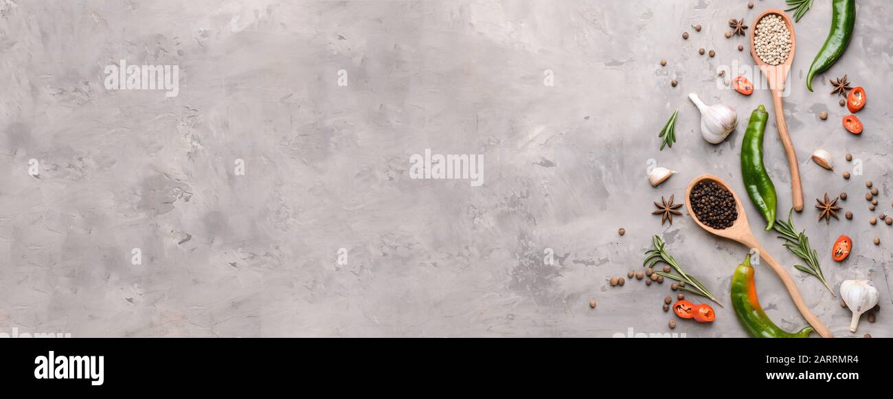 Different spices on grey background with space for text Stock Photo